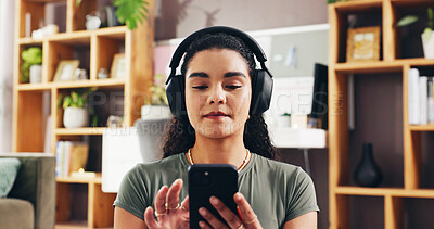 Buy stock photo Woman, phone and headphones with music in home, scroll and mobile app for streaming in lounge. Girl, smartphone and click with subscription, relax and listen to audio, album or song in living room