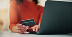 Woman, hands and credit card with laptop for online shopping, payment or banking in home. Closeup, female person or shopper with debit on computer for ecommerce, wireless transaction or app purchase