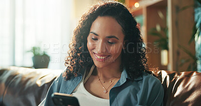 Buy stock photo Typing, phone and smile with woman on sofa for social media, communication and networking app. Reading, news update and chat forum with person in home for text message, connection and contact