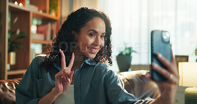 Buy stock photo Woman, selfie and peace sign on sofa in home, photography and post on web in living room. Girl, influencer and happy on couch with profile picture, symbol or live stream on social network at house