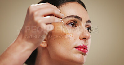 Buy stock photo Serum, beauty and skincare with woman in studio for cosmetics, dermatology and collagen benefits. Hyaluronic acid product, oil and facial treatment with person on background for self care and space