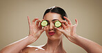 Cucumber, skincare and glow with woman in studio for organic cosmetics, hydration benefits and beauty. Natural product, self care and antioxidant with person on background for puffy eye treatment
