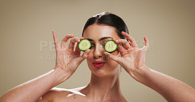 Buy stock photo Cucumber, skincare and glow with woman in studio for organic cosmetics, hydration benefits and beauty. Natural product, self care and antioxidant with person on background for puffy eye treatment