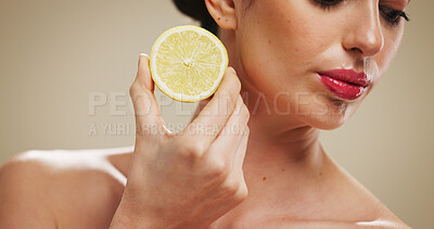 Buy stock photo Beauty, woman and skincare with lemon, studio background or natural cosmetic for anti aging benefits. Skin, hydration and person with fruit for glow, facial treatment and dermatology for smooth face