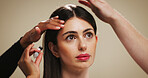 Woman, beauty and hair with treatment for styling or cosmetics on a studio background. Female person, model or thinking with makeup, style or haircare in dermatology or cosmetology for spa or salon