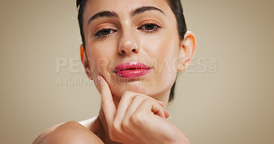 Buy stock photo Portrait, makeup and woman in studio with lipstick, aesthetic or beauty with shine. Face, cosmetics and confident model with skincare, wellness or facial transformation on brown background space