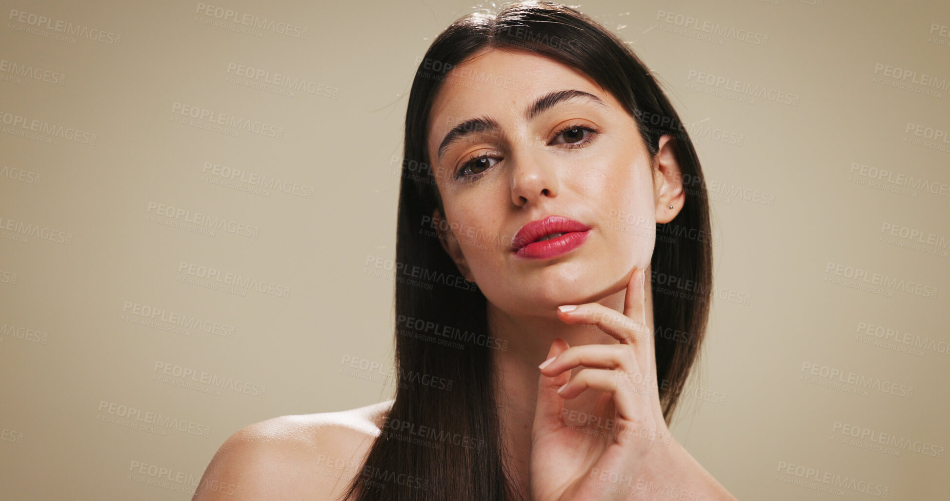 Buy stock photo Portrait, beauty and woman with lipstick for makeup, aesthetic and self care with glow. Serious face, cosmetics and confident model with shine, cosmetology or skincare on brown studio background