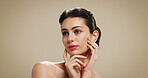 Skincare, beauty and woman in studio with makeup for salon aesthetic, makeover and cosmetics. Dermatology, mockup space and face of person with facial glow, shine and self care on brown background 