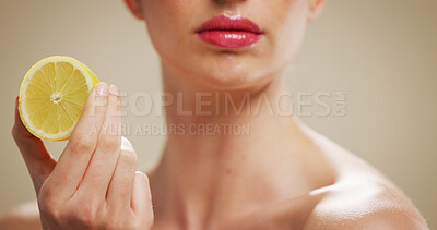 Buy stock photo Lemon, skincare and lips of woman in studio for organic cosmetics, vitamin c benefits and glow. Natural product, self care and antioxidant with person on background for shine, fruit and beauty