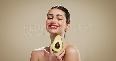 Buy stock photo Woman, avocado and beauty studio portrait with smile, makeup or pride with mockup space on background. Girl, happy and confident with sustainable cosmetics, fruit and results with wellness in Turkey