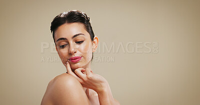 Buy stock photo Skincare, beauty and face of woman in studio with makeup for salon aesthetic, makeover and cosmetics. Dermatology, mockup space and person with facial glow, shine and self care on brown background 