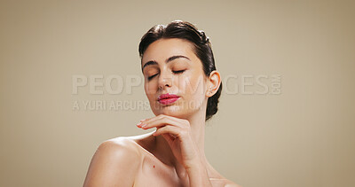 Buy stock photo Makeup, beauty and face of woman in studio with eyes closed for salon aesthetic, makeover and cosmetics. Dermatology, mockup and person with skincare, shine and self care on brown background space