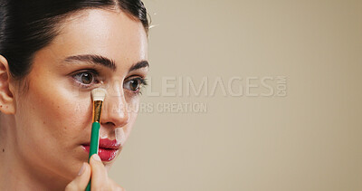 Buy stock photo Makeup brush, beauty and woman with concealer in studio for application, aesthetic or mockup space. Cosmetics, model and tools for foundation, product and facial transformation on brown background