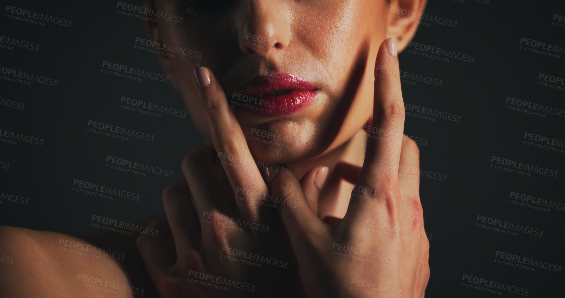 Buy stock photo Beauty, hands and mouth of model on black background for cosmetics, dermatology or wellness. Lipstick, skincare and touch with woman in dark studio for facial aesthetic, makeup or face treatment