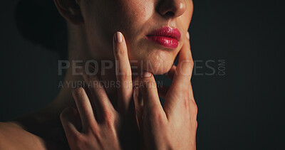 Buy stock photo Makeup, red lipstick and face of woman in studio with beauty, self care or cosmetics. Skincare, hands and female person with natural facial glow for dermatology routine by black background with space