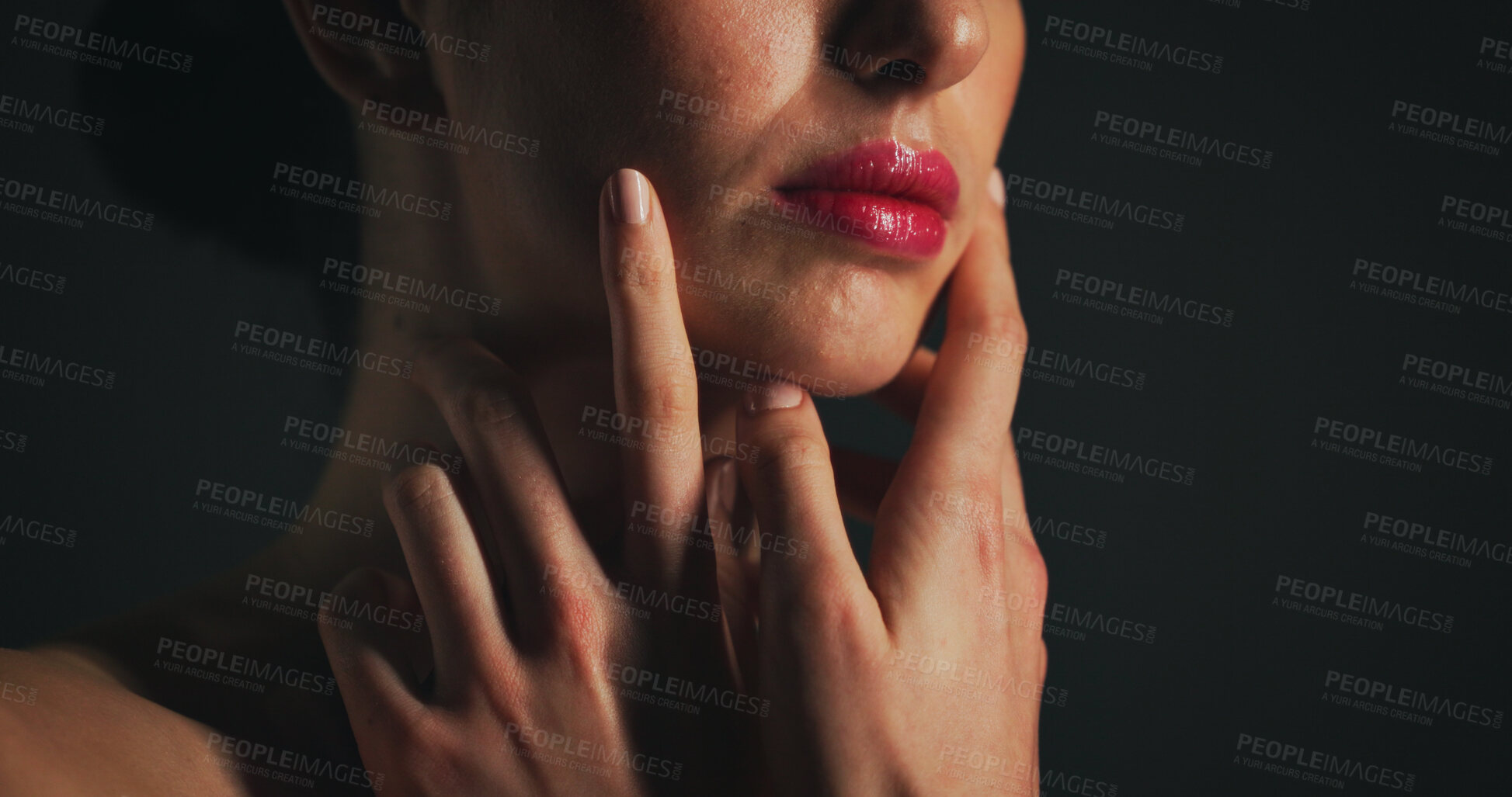 Buy stock photo Makeup, red lipstick and face of woman in studio with beauty, self care or cosmetics. Skincare, hands and female person with natural facial glow for dermatology routine by black background with space