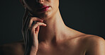 Shoulder, glow and hand of woman in studio for dermatology, body care and hygiene. Collagen benefits, aesthetic and shine with closeup of person on black background for space, grooming and touch