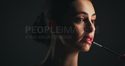 Buy stock photo Makeup, brush and woman in studio with lipstick, beauty or facial routine with products. Cosmetics, self care and female person with tool for face cosmetology treatment for glow on black background