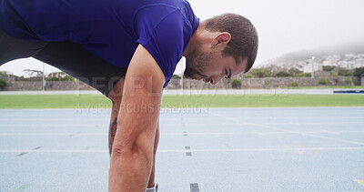Buy stock photo Runner, man and ready at start line on track for running practice, race fitness or cardio at stadium. Athlete, set and take off position for endurance exercise, sports performance and pace training