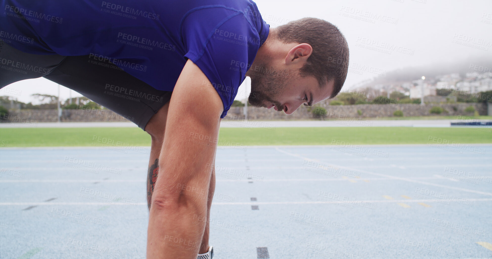 Buy stock photo Runner, man and ready at start line on track for running practice, race fitness or cardio at stadium. Athlete, set and take off position for endurance exercise, sports performance and pace training