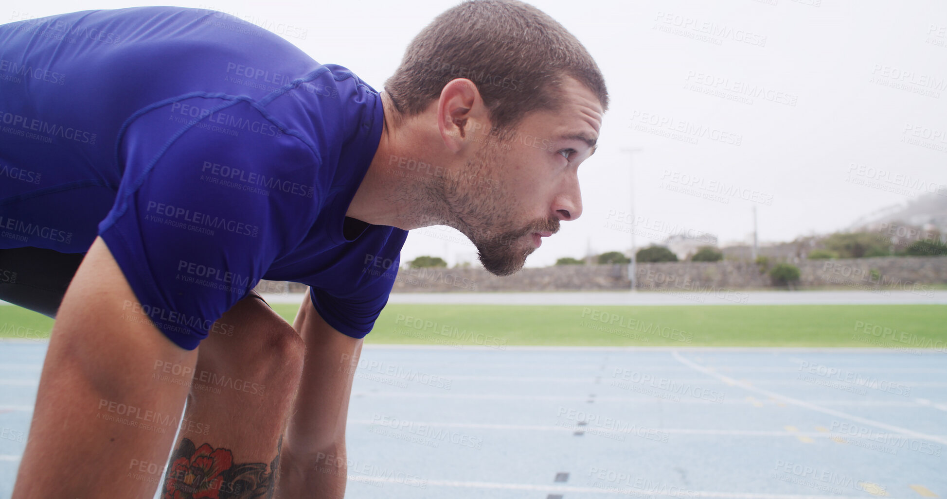 Buy stock photo Athlete, man and set to start on track for cardio workout, marathon training and race at stadium. Champion, getting ready and take off for competition fitness, running exercise and sports performance