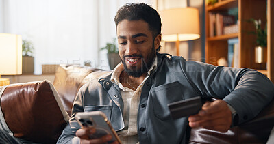 Buy stock photo Happy man, phone and sofa with credit card for online shopping, payment or remote banking in home. Male person, smile and mobile smartphone with debit for ecommerce app, purchase or order in house