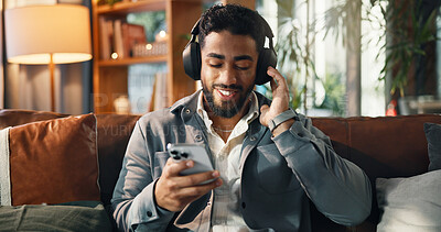 Buy stock photo Happy, man and phone with headphones on sofa for streaming subscription, audio playlist or song. Smile, person and relax with smartphone in lounge for listening to radio and feel good album in home