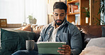 Remote work, man and coffee with tablet in home for small business development, research or report. Freelance entrepreneur, person and digital app on sofa for startup planning and reading proposal