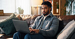 Freelancer, laptop and typing with man on sofa for article research, blog writer and reading. Journalist planning, remote worker and draft editing with person in living room of home for publishing