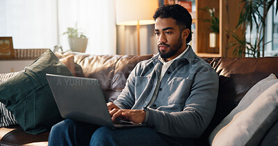Buy stock photo Freelancer, laptop and typing with man on sofa for article research, blog writer and reading. Journalist planning, remote worker and draft editing with person in living room of home for publishing