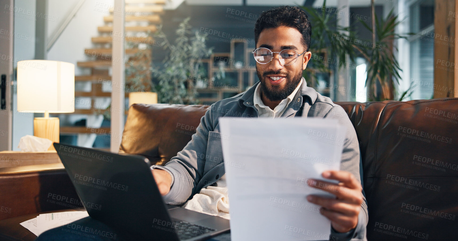 Buy stock photo Happy man, laptop and sofa with documents for finance, budget planning or expenses in home. Male person, audit and reading invoice with computer for financial checklist, mortgage or contract loan