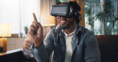 Buy stock photo Virtual reality, pointing and man on sofa in home for online gaming, metaverse or connection. Happy, living room and person with VR headset for futuristic user experience, simulation or entertainment