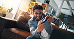 Man, video game and excited with controller on sofa for online competition, challenge and happy in home. Person, gamer and play with strategy for next level, esports or digital contest in living room