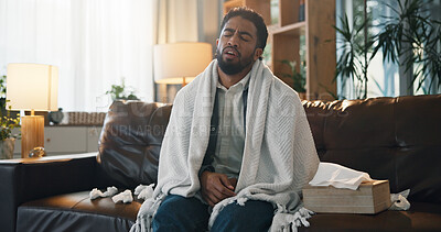Buy stock photo Home, sick and man on sofa, flu and tissue with fatigue, cold and virus infection. Apartment, blanket and person on couch, illness and sinus fever with disease, exhausted and allergy with recovery