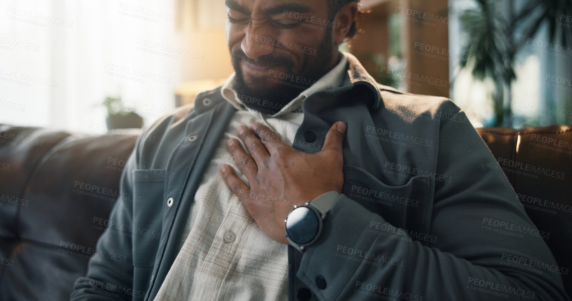 Buy stock photo Home, heart attack and man on sofa, chest pain and asthma with emergency in living room. Apartment, cardiac arrest and person on couch, cardiovascular and hypertension with pressure and health fail
