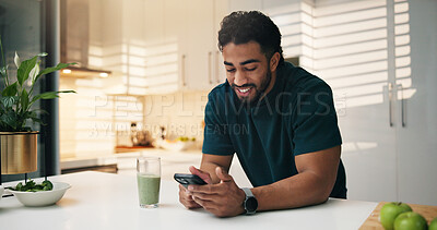 Buy stock photo Cellphone, smoothie and man in kitchen in morning with networking, communication or mobile app. Technology, health drink and male person with phone for texting, contact or social media in apartment.