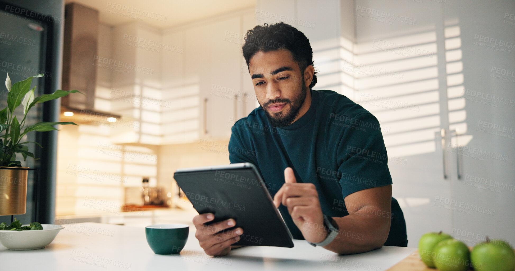 Buy stock photo Tablet, coffee and man in kitchen in morning with networking, communication or app. Digital technology, research and male person with cappuccino for texting, contact or social media in apartment.