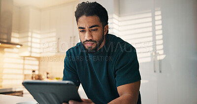 Buy stock photo Tablet, reading and man in kitchen in morning with networking, communication or mobile app in home. Digital technology, research and male person thinking for texting, contact or social media in house