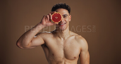 Buy stock photo Portrait, man and skincare with grapefruit, self care or smile for natural cosmetics or dermatology. Studio background, glow and clear skin with fruit, health and facial treatment for wellness in USA