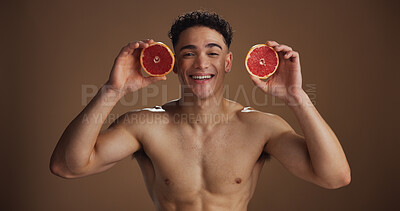Buy stock photo Portrait, man and skincare with grapefruit, studio background and natural cosmetics for dermatology. Soft, glow and smooth skin with fruit, health or facial treatment for wellness or self care in USA