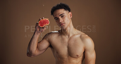 Buy stock photo Portrait, man and skincare with grapefruit, pride and healthy with natural cosmetics or dermatology. Studio background, glow and clear skin with fruit, self care and facial treatment for wellness