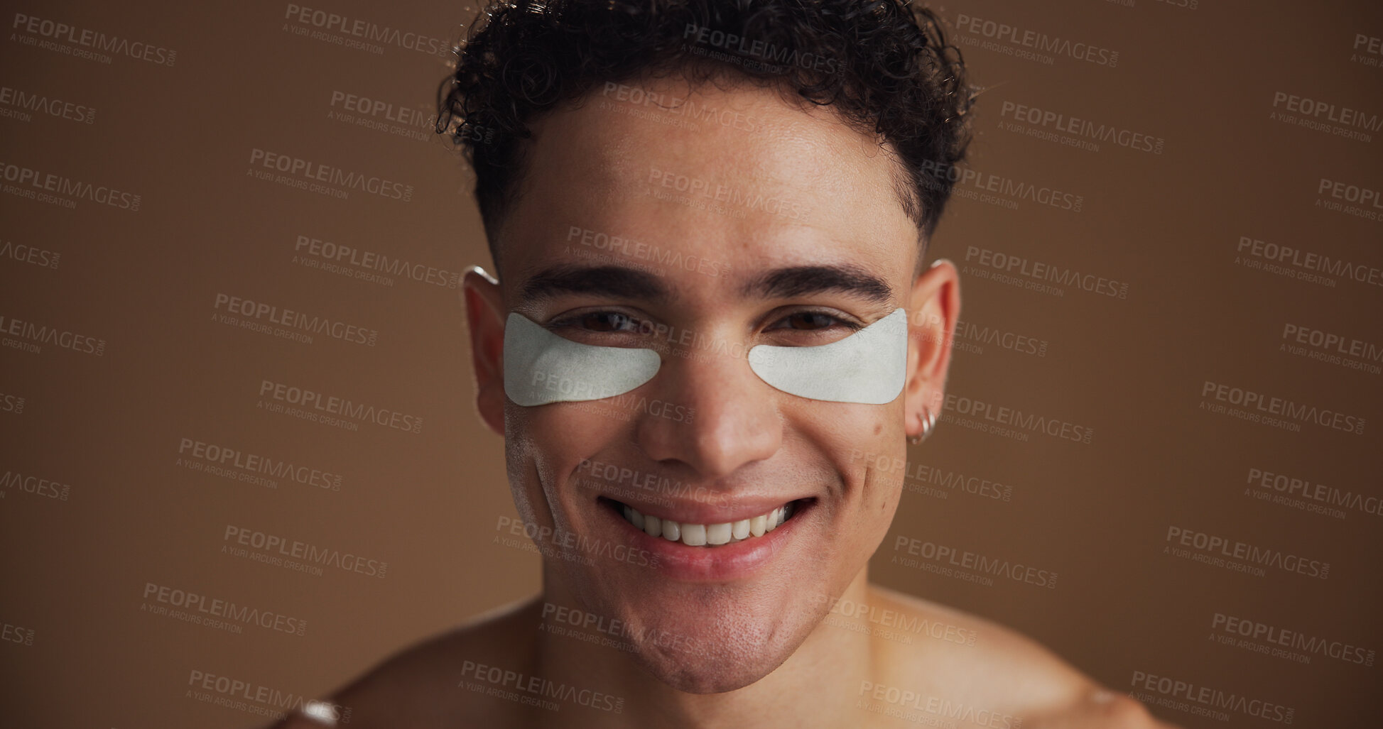 Buy stock photo Natural, eye pads and portrait of man in studio for beauty, skincare or grooming for facial routine. Happy, cosmetics and person with collagen patches for dermatology treatment by brown background.