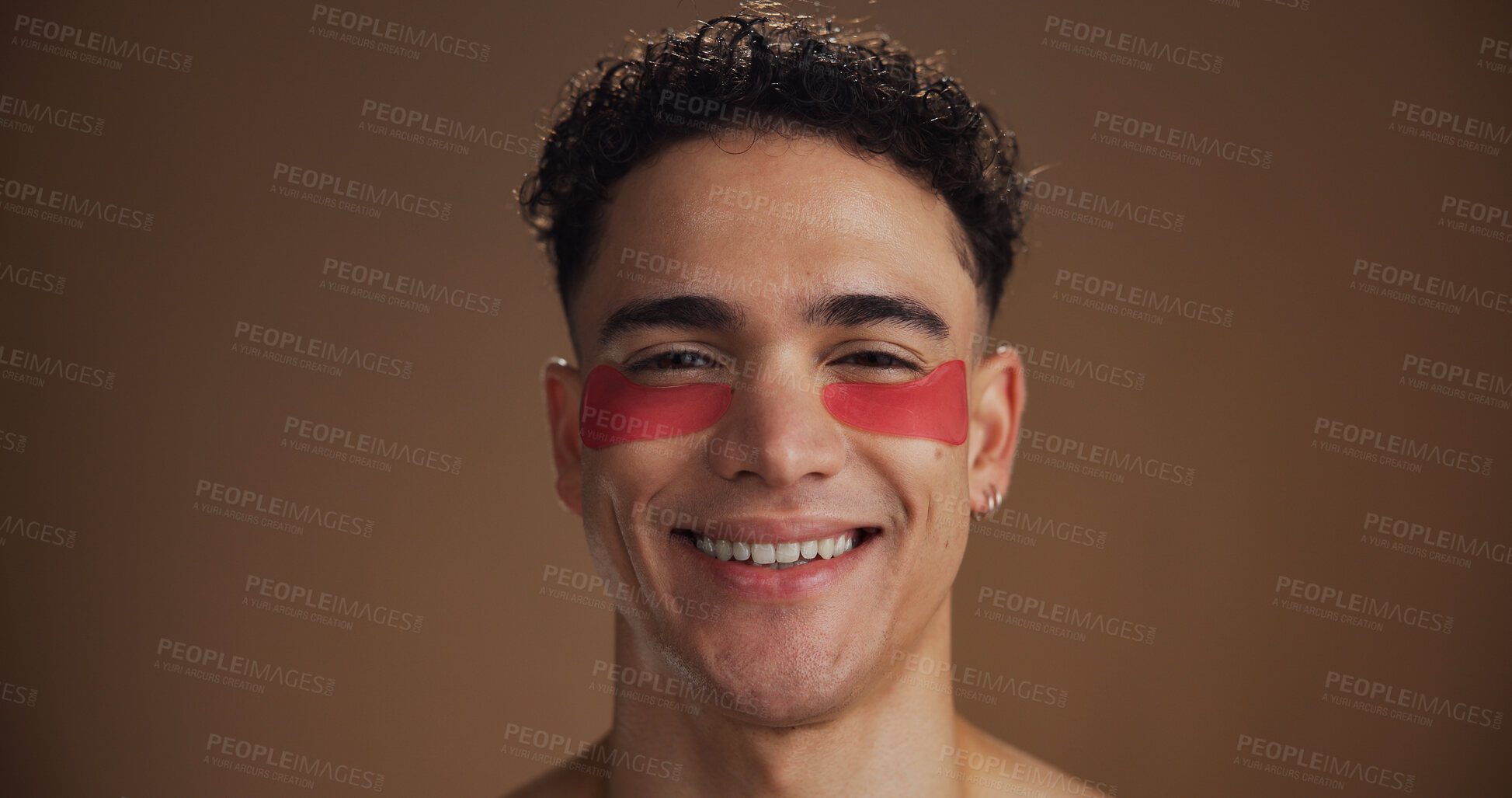 Buy stock photo Skincare, eye mask and portrait of man in studio for wellness, hydration and dermatology. Mockup space, salon and face of person for anti aging, grooming and facial treatment on brown background