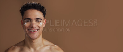 Buy stock photo Mockup space, face cream and portrait of man in studio for natural, beauty or facial routine with hydration. Skincare, banner and male person with sunscreen for dermatology by brown background.