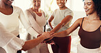 Happy, group and women with hands in yoga class for exercise, pilates workout or wellness. Friends, trainer and people with stack at fitness club for health, support and motivation in studio together