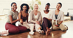 Happy, group and portrait of women in yoga class for exercise, pilates workout and wellness. Friends, trainer and people on floor together at fitness club for health, mobility and wellbeing in studio