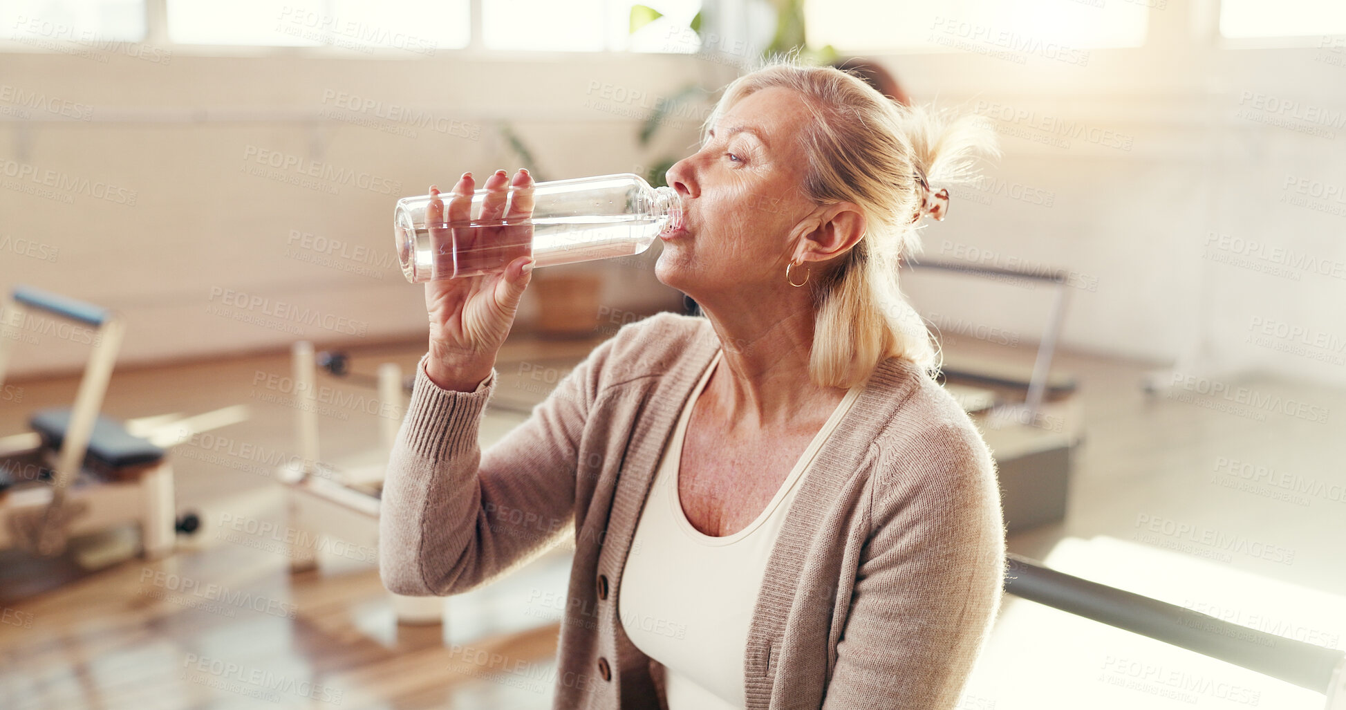 Buy stock photo Pilates class, woman and drinking water with break for hydration, exercise recovery and thirsty. Fitness, mature person and liquid bottle at studio for workout refresh, nutrition or rest from routine
