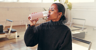 Buy stock photo Pilates class, girl and drinking water in studio for hydration, exercise recovery and break. Fitness, person and thirsty with mineral bottle for workout refresh, nutrition and resting from practice