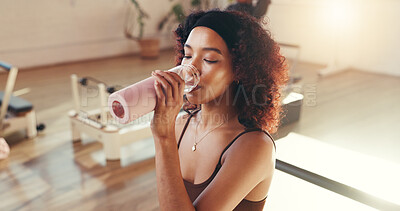 Buy stock photo Pilates class, woman and drinking water with hydration for exercise recovery, break or thirsty. Fitness, african person and liquid bottle at studio for workout refresh, self care or rest from routine