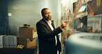 Man, detective and board for investigation in office, pointing at evidence or documents with link for criminal case. Mature African policeman, mindmap and problem solving with crime analysis at night